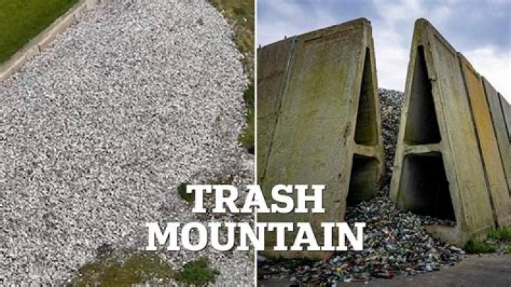 A huge mountain of waste is seen in front of empty skips 
