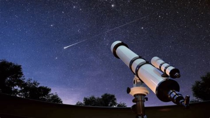 A telescope pointing at a bright object in the night sky.