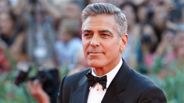 Clooney greets fans as he arrives at the opening ceremony and
