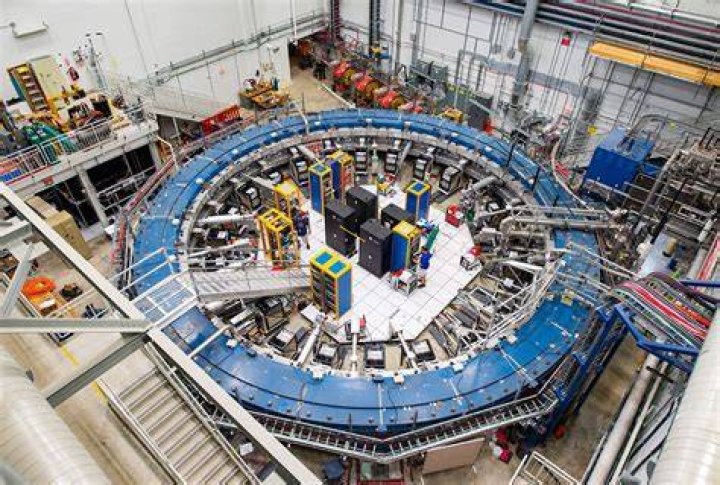 Dr Alex Keshavarzi next to the muon g-2 ring in the Fermilab.
