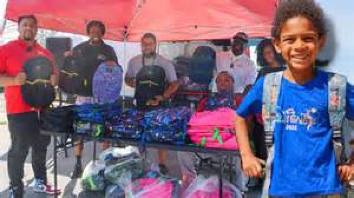 Kids receive backpacks