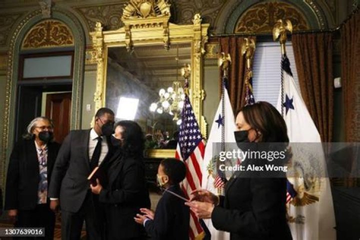 Michael Regan kisses his wife Melvina Regan as son Matthew Regan and