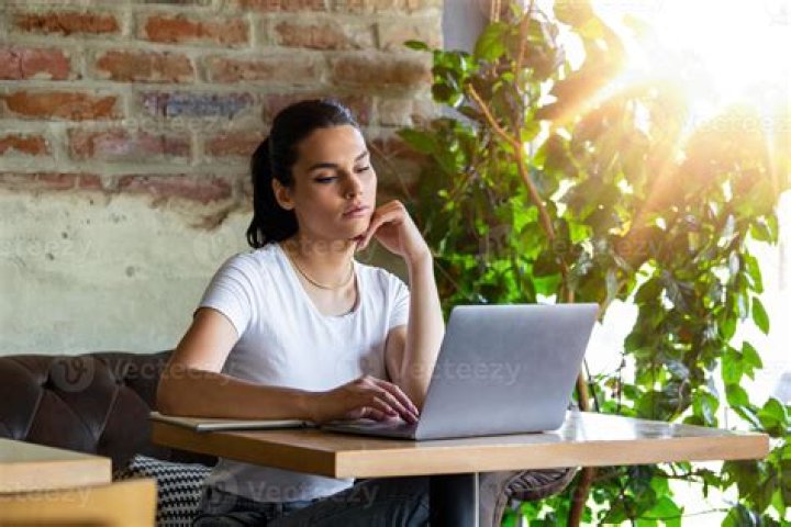 Person looking and working on a laptop