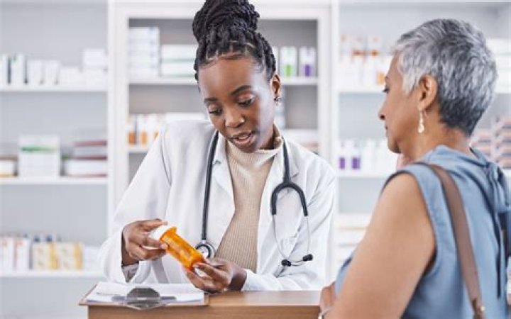 Pharmacist labelling a patients medicine