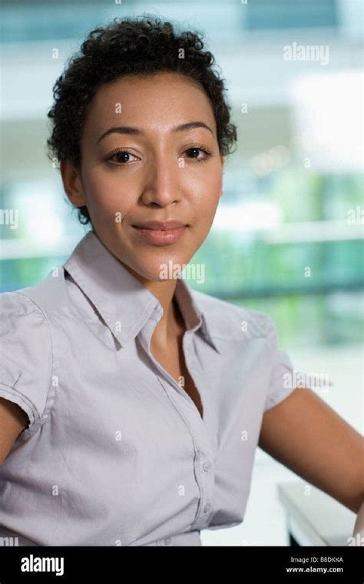 Portrait of an office worker using laptop and headset.