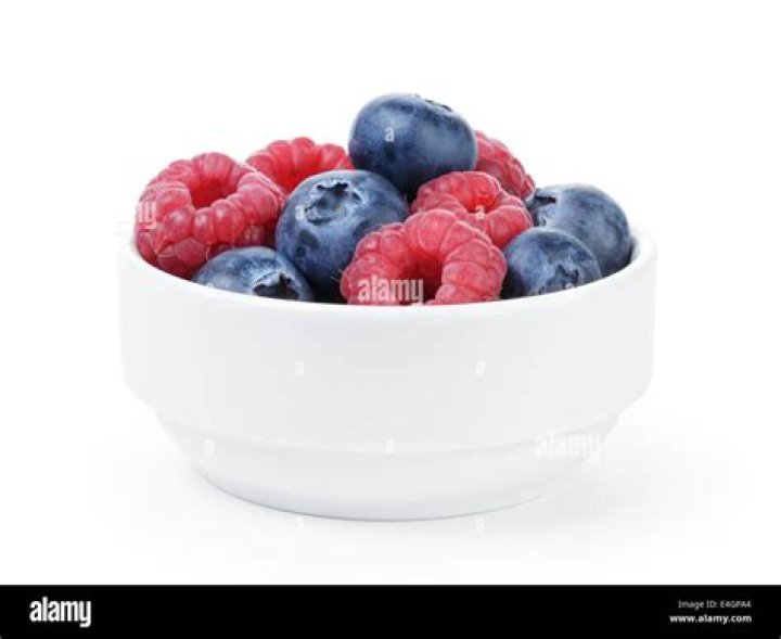 Ripe Blueberries and Raspberries in Two Bowls. Stock Photo Image of
