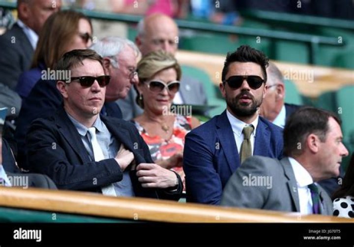 Sam Spruell (left) and Dominic Cooper in the royal box on centre court