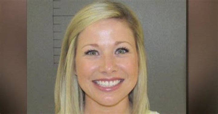 Smiling mugshot of teacher accused of inappropriate relationship with