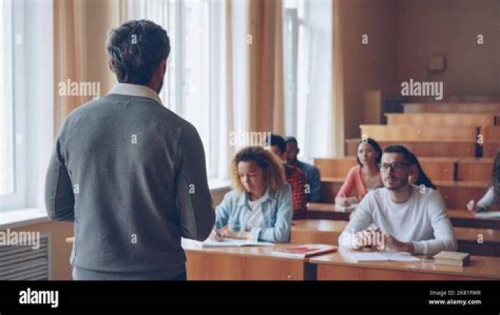 Student listening to professor in classroom with other students