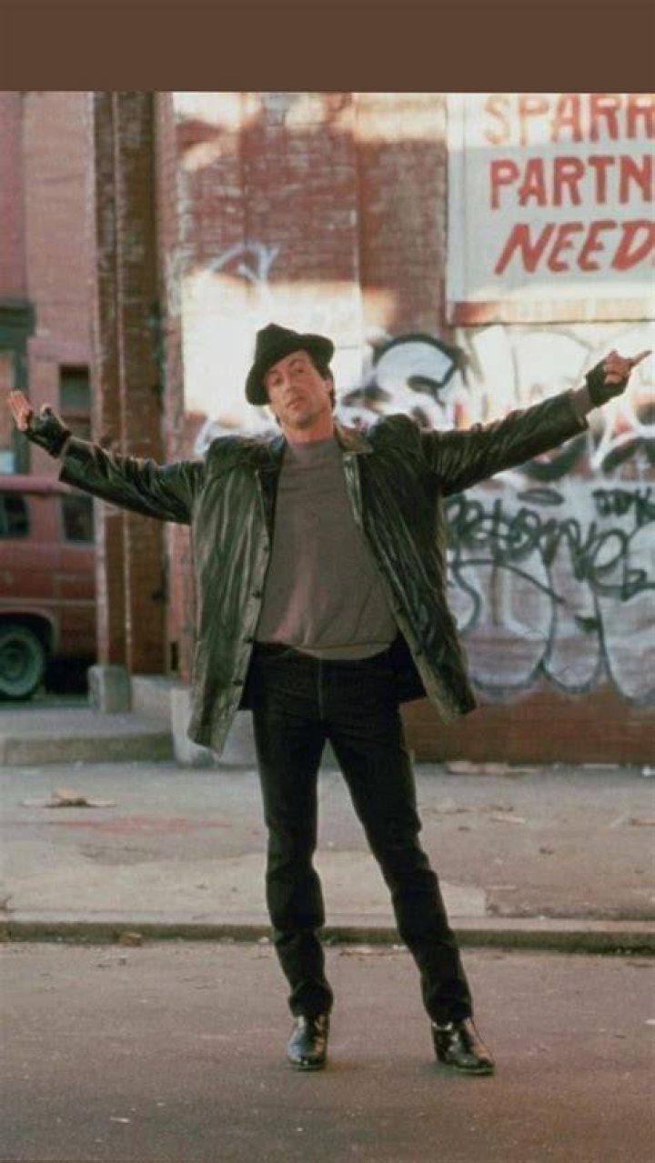 Sylvester Stallone poses for a picture with a fan in a wheelchair