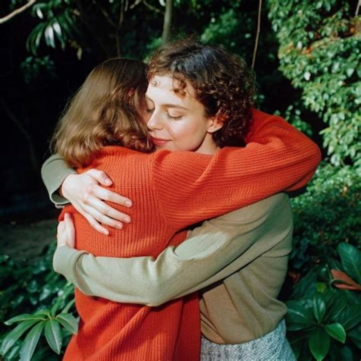 Two friends hugging each other.